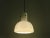 The lamp has a calyx shape made of thick white opaline glass and a metal socket with an E 27 fitting, which is fixed in...