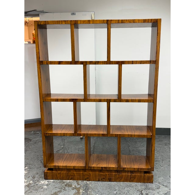 Design Plus Gallery presents a French Lacquered Étagère Bookcase, Circa 1940's. This architectural shelving unit showcases...