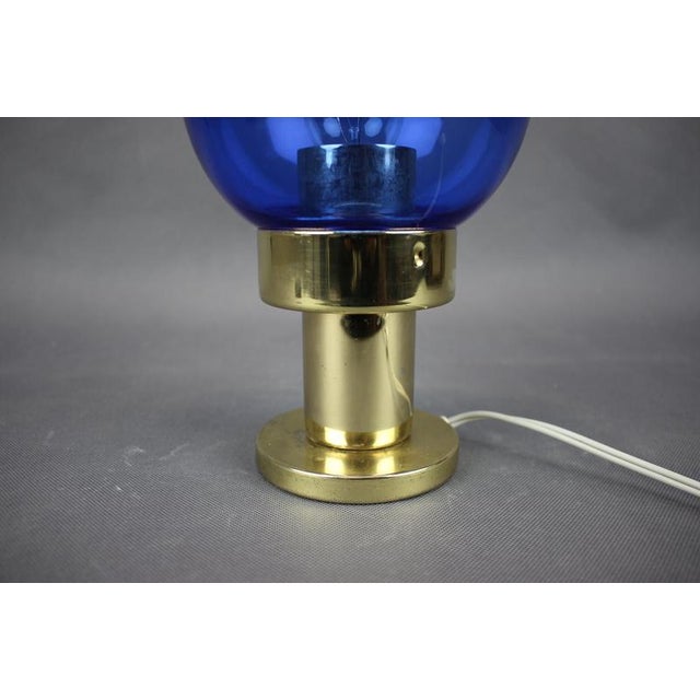 Original table lamp produced in Kamenický Šenov, Czechoslovakia during the 1970s. This elegant modernist lamp features a...