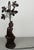 A decorative Vintage French lamp featuring a detailed seated female figure, an elegant curved upright and sculptural leaf...