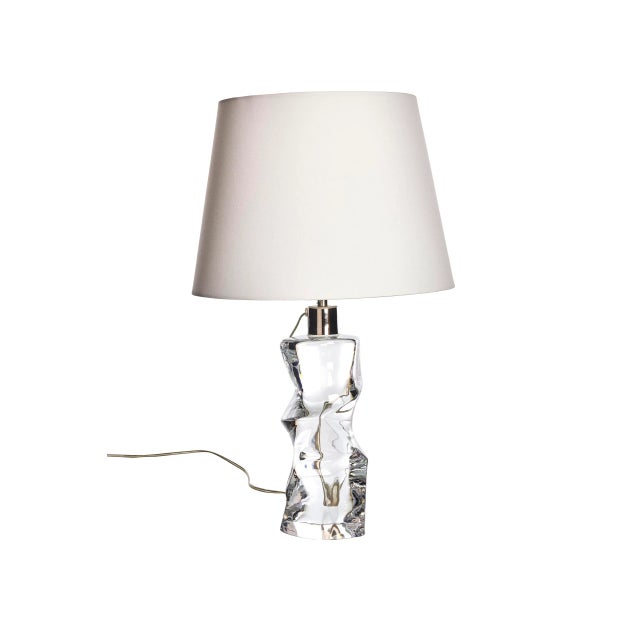 The lamp's base, meticulously sculpted from premium crystal glass, creates a captivating display of light and reflection....