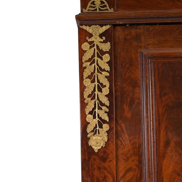 Bookcase/wardrobe, France, circa 1800/1810; very fine pyramid-patterned mahogany with brass hardware; can be disassembled;...