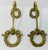 Pair of brass curtain holdbacks with a beautiful wreath and ribbon design.
