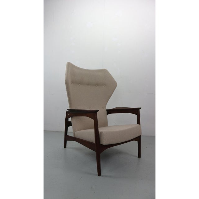 Wingback lounge chair designed by Ib Kofod-Larsen in 1954. The chair is reclinable and it can be adjusted in three...