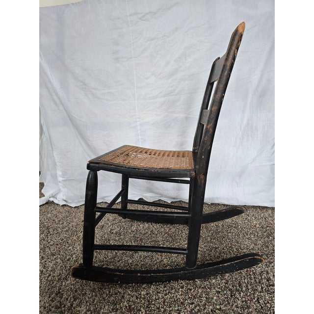 Authentic late 19th-century antique child’s rocking chair featuring classic rocker feet and a hand-caned seat. Solid wood...