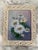 Floral still life oil painting of daisies circa the mid-20th century. Painting of purples, blues, greens, whites and...