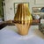 The Jonathan Adler Gold Belly Ribbed Pottery Vase is a vintage piece from the late 20th century, showcasing a mid-century...