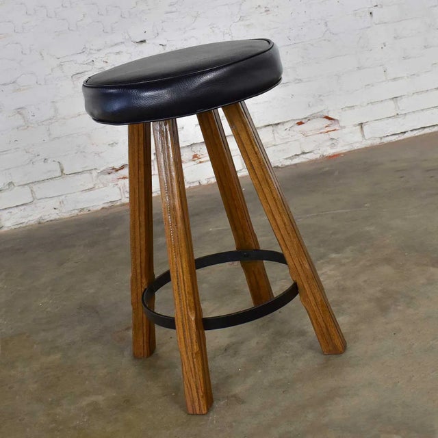 Beautiful swivel bar stool attributed to A. Brandt comprised of solid ranch oak and a dark brown almost black vinyl or...