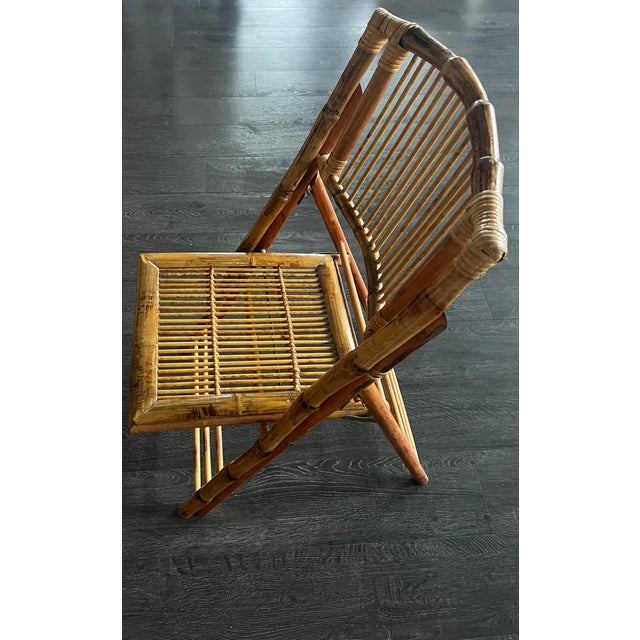 Beautiful set of four vintage bamboo folding lounge chairs crafted from solid natural bamboo with a warm aged patina....