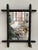 A charming early 20th-century French Provincial wall mirror featuring a hand-turned wood frame crafted in imitation of...