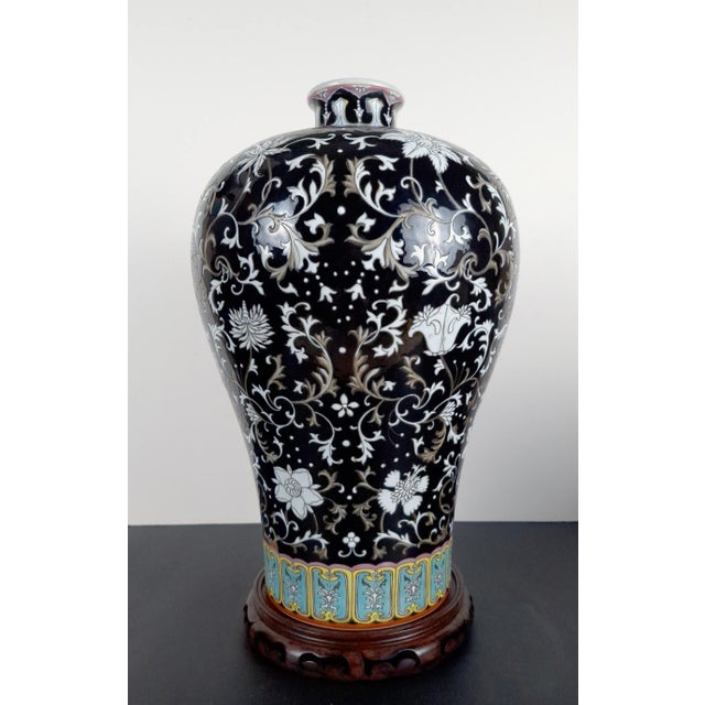 Chinese porcelain floral meiping, a finely formed, plum shape vase with a white on black with light umber highlights,...