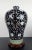 Chinese porcelain floral meiping, a finely formed, plum shape vase with a white on black with light umber highlights,...