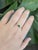 A rare tsavorite garnet rests in a vivid grass green at the centre of this solid 14K yellow gold ring, surrounded by four...