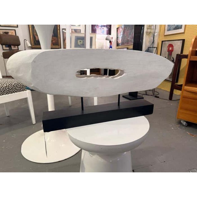 Hand-carved and painted in matte white, this abstract wooden sculpture by Los Angeles artist Charles Fultz captures the...