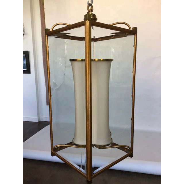 Antique gold gilded finished iron lantern with brass accents and an interior silk shade.