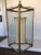 Antique gold gilded finished iron lantern with brass accents and an interior silk shade.