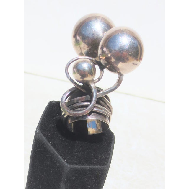 Sterling silver modernist construction of sculptural elements designed around rising spheres of silver wound around a...