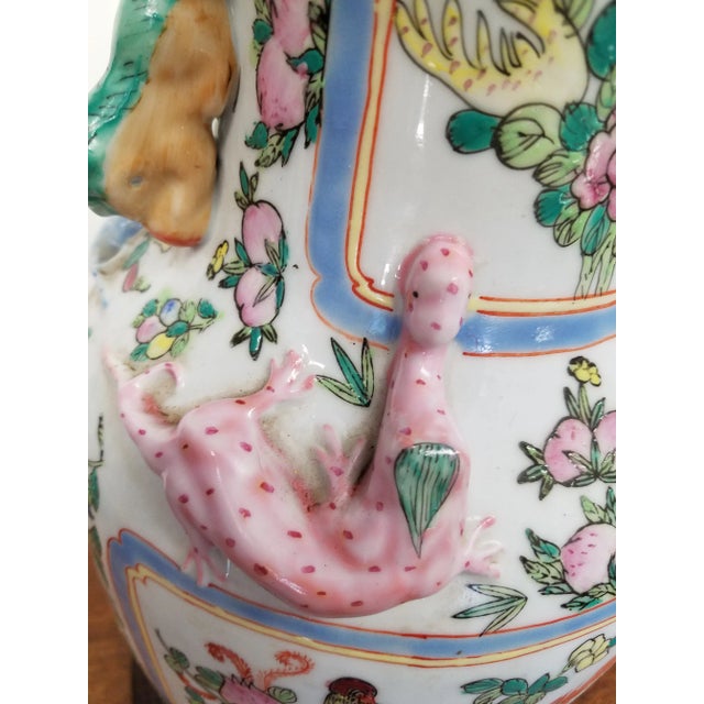 Chinese Vase with pretty colors decrated with all sorts of flowers and creature's. Hand painted from the 1950s.or 60s.