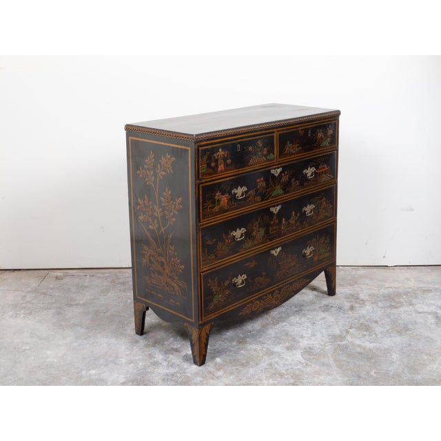 An English black commode from the 19th century, with Chinoiserie low-relief décor, guilloche motifs and five drawers....