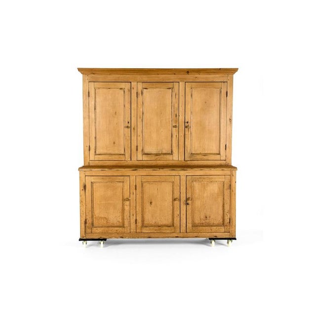 A large Victorian House keepers cupboard, the top with a gently oversailing cornice with an arrangement of three tall...