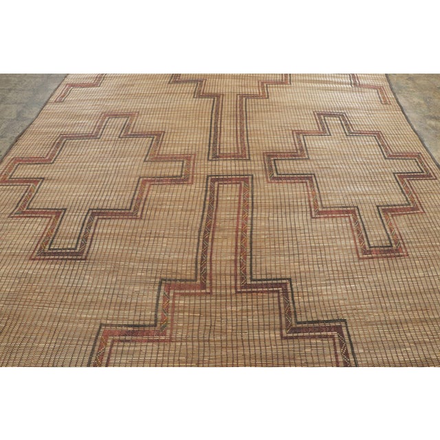 This vintage Moroccan mat is a primitive 9x12 Tuareg work from the nomadic tribe of the same name. Handwoven with reeds...