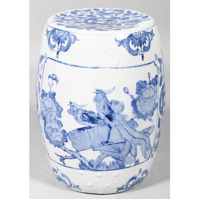 CHINESE UNDERGLAZE BLUE AND WHITE GARDEN STOOL of barrel shape, decorated with birds and flowers in panels with incurved...