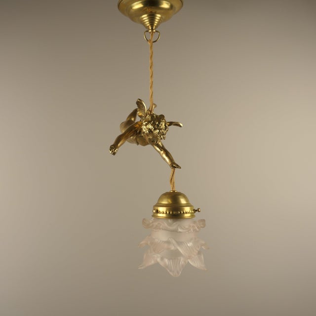 French Angel Figure in Massive Brass. The light provides a pleasant, glare-free light. Polished surface. The luminaire has...