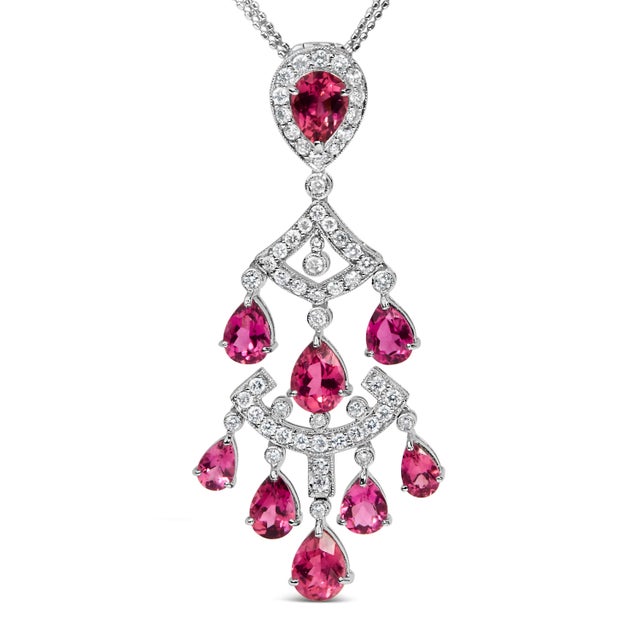 Embrace an era of resplendent glamour with this 18K white gold pendant necklace, exquisitely adorned with dazzling natural...