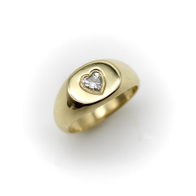 This 14k gold ring plays with the idea of a signet ring and features a beautiful heart-shaped natural diamond as its...