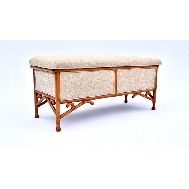 An Arts and Crafts period bench of steam bent oak construction with exposed framework, turned ball feet and curved brass...