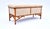 An Arts and Crafts period bench of steam bent oak construction with exposed framework, turned ball feet and curved brass...