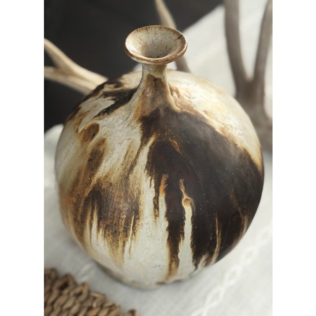 Signed Gaynor studio pottery vessel with an organic bottle form and dramatic flame-marked surface. Hand-thrown stoneware...