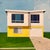 Smell the Sea by Justin Wheatley | Acrylic on Canvas of a modern yellow house with windows For Sale
