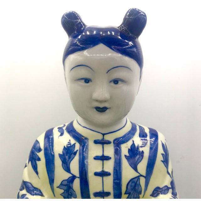 Hand painted Imperial Court Girl Holding Plate. Blue and White yet jacket is in a light yellow. Stands near 13" tall....