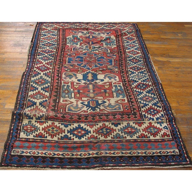 Antique Caucasian - Kazak rug 4'7"x 6'6". Antique Caucasian, Kazak Rug with an ivory background and patterned border. This...