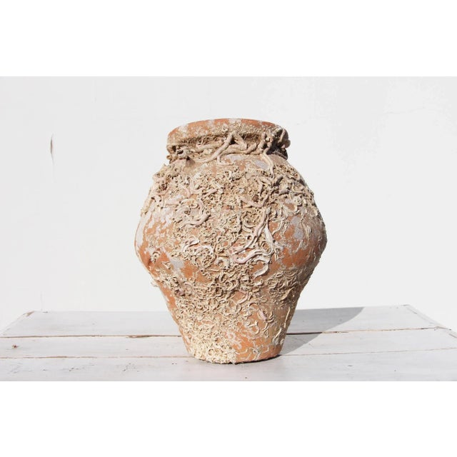 An hand made terracotta pot originally submerged under sea and used as a trap for an individual octopus. This pot has a...