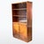 Art Deco bookcase from the 1930s, made of walnut veneer with a distinctive wood grain. Upper section with sliding glass...