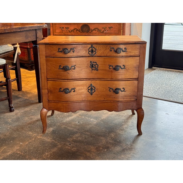 Small Italian lift-top chest constructed with a shaped plank top hinged to open to a compartmented interior. The case is...