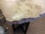 Petrified wood slab on a steel base. 22” wide. “Petrified wood is a fossil formed when wood is buried in waterlogged,...