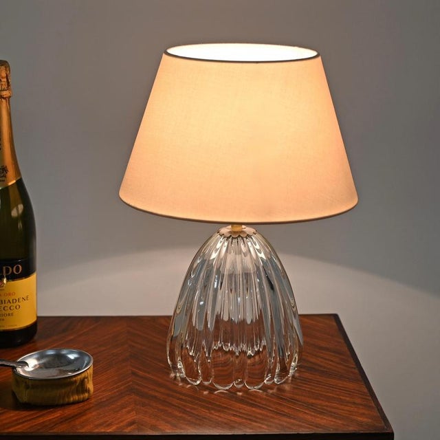 Wonderful table lamp in murano blown glass and brass, completed by a light pink cotton lampshade. This elegant lamp was...