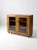 This is an antique display cabinet. The primitive wooden curio cabinet features double glass paned doors with three...