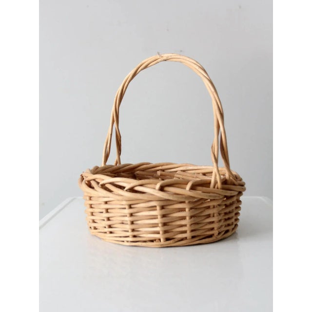 Ideal as a catchall, this vintage wicker basket features a twisted top handle. The sturdy woven basket's basin is great...