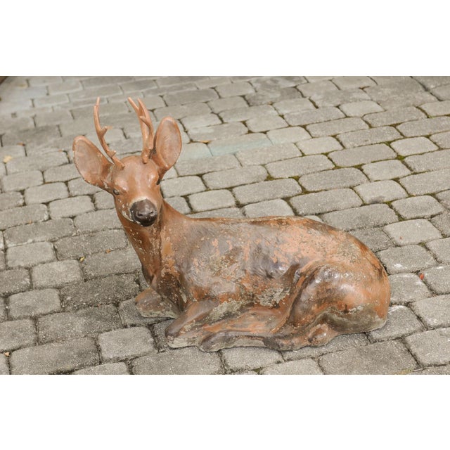 A vintage American concrete deer sculpture with iron antlers and weathered patina. Born during the first half of the 20th...