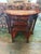 Striking vintage Chinese-style carved hardwood demilune console featuring a beautiful inset marble top. The elegant half...