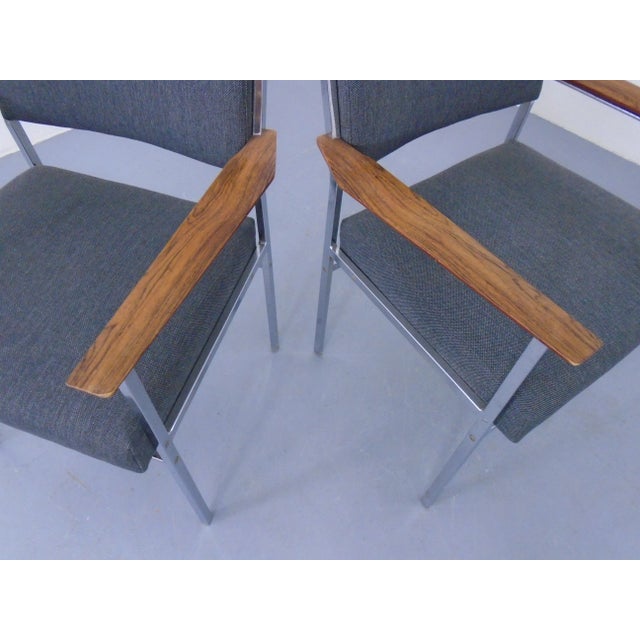 - Set of two chairs with tulipwood armrests - Newly upholstered in grey fabric