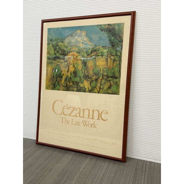 Design Plus Gallery presents a framed Cézanne “The Late Work” exhibition poster from The Museum of Modern Art, New York....