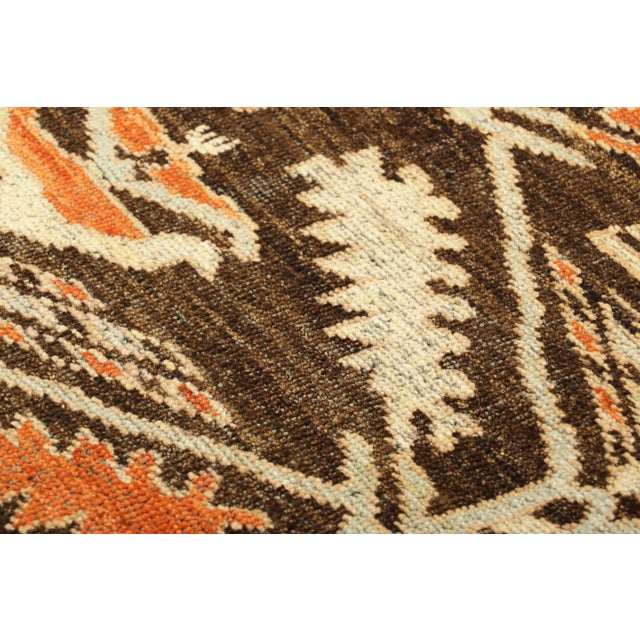 Hand-knotted in wool, this 2x3 classic oriental rug from India presents a lively interpretation of tribal design...