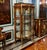 Showcase your most treasured collectibles in this magnificent French Louis XV Curio Display Cabinet, a luxurious statement...