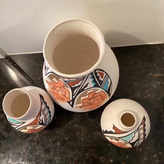 This beautiful three-piece, Native American style pottery vases feature a unique open work design with painted motives,...