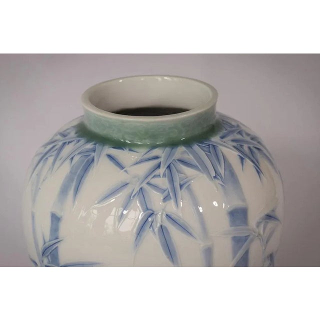 An exquisite piece of Japanese pottery. With a harmonious palette of white paired with soft blue and green, the raised...